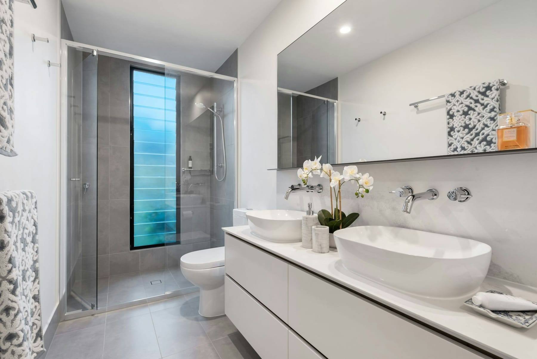 Bathroom with a double vanity and walk-in shower